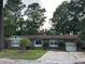 Charming single-story home with brick facade, landscaped front yard, and attached garage at 8334 Witsell St, North Charleston, SC 29406
