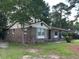 Brick single-story house with green grass yard and beautiful curb appeal at 8334 Witsell St, North Charleston, SC 29406
