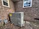 Image shows the home's HVAC system against the brick exterior with nearby gas and electric meters at 8334 Witsell St, North Charleston, SC 29406