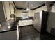 Traditional style kitchen with white cabinets, black countertops, and stainless steel appliances at 8334 Witsell St, North Charleston, SC 29406