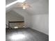 This attic boasts a ceiling fan, high vaulted ceilings, and a stylish railing at Way, Goose Creek, SC 29445