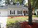 Charming single-story home featuring a garage, manicured front yard, and classic architectural details at Way, Goose Creek, SC 29445