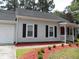 Charming home with black shutters, brick chimney, and landscaped yard at Way, Goose Creek, SC 29445