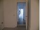 Open hallway leads to a naturally lit staircase and bright living space beyond at Way, Goose Creek, SC 29445