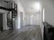 Bright living room boasts new flooring, soaring ceilings, and spiral staircase leading to upper level at Way, Goose Creek, SC 29445