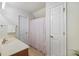 Bright bathroom with cream countertops, white cabinets, and a patterned shower curtain at 1005 Yellow Hawthorn Circle, Summerville, SC 29483