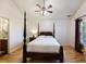 Main bedroom featuring a four-poster bed, wood floors, and window with blinds at 1005 Yellow Hawthorn Circle, Summerville, SC 29483