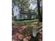A two-story house features a spacious balcony and a large yard enclosed by a rustic wooden fence at 102 Webb St, Bonneau, SC 29431
