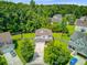 Aerial view of a two-story home in a lush, green neighborhood with mature trees and well-maintained lawns at 104 Study Ct, Ladson, SC 29456