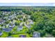 Aerial view of a residential neighborhood with lush greenery and well-maintained homes at 104 Study Ct, Ladson, SC 29456