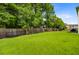 Expansive backyard with lush green grass and a wooden fence, perfect for outdoor activities and privacy at 104 Study Ct, Ladson, SC 29456
