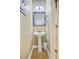 Compact bathroom with pedestal sink, decorative mirror, and tiled flooring at 104 Study Ct, Ladson, SC 29456