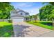 Traditional two-story home with a two-car garage, an ample lawn, and mature shade trees at 104 Study Ct, Ladson, SC 29456