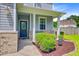 Inviting front entrance with covered porch, decorative door, and manicured landscaping at 104 Study Ct, Ladson, SC 29456