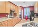 Well-lit kitchen featuring neutral countertops, modern appliances, and ample cabinet space at 104 Study Ct, Ladson, SC 29456