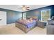 Serene main bedroom boasting natural light, a ceiling fan, and neutral carpeting at 104 Study Ct, Ladson, SC 29456