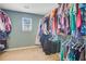 Large walk-in closet features wall-to-wall racks for storing clothing at 104 Study Ct, Ladson, SC 29456