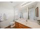 Well-lit bathroom featuring a single sink vanity with a large mirror and tiled floor at 105 Brockman Way, Goose Creek, SC 29445