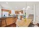 Kitchen with hardwood floors, wood cabinetry, a peninsula with barstools, and a dining area at 105 Brockman Way, Goose Creek, SC 29445