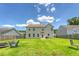 Wide backyard view featuring lawn, patio, firepit area, and privacy fence at 109 Cypress Plantation Rd, Moncks Corner, SC 29461