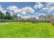 Spacious fenced backyard with lush green grass and seating area for outdoor enjoyment at 109 Cypress Plantation Rd, Moncks Corner, SC 29461