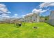 A home backyard featuring a fire pit area with seating on a large lawn with green grass at 109 Cypress Plantation Rd, Moncks Corner, SC 29461