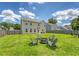 A seating area with firepit is the central feature of this lush and green back yard at 109 Cypress Plantation Rd, Moncks Corner, SC 29461