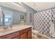 A bathroom featuring blue walls, a shower with a patterned curtain, and a wood vanity at 109 Cypress Plantation Rd, Moncks Corner, SC 29461