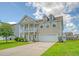 Charming two-story home featuring a welcoming front porch, attached two-car garage, and well-manicured lawn at 109 Cypress Plantation Rd, Moncks Corner, SC 29461