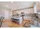 Well-lit kitchen with granite countertops and an island with barstool seating at 109 Cypress Plantation Rd, Moncks Corner, SC 29461