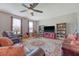 Comfortable living room with ceiling fan, stylish rug, and shelving for storage and display at 109 Cypress Plantation Rd, Moncks Corner, SC 29461