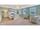 This charming main bedroom features a ceiling fan, sitting area and lots of natural light at 109 Cypress Plantation Rd, Moncks Corner, SC 29461
