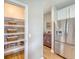 Pantry with shelving providing ample storage space next to a stainless steel refrigerator at 109 Cypress Plantation Rd, Moncks Corner, SC 29461