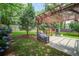 This backyard features a pergola, barbeque and concrete patio amidst a lawn at 110 Bayberry Run, Summerville, SC 29485