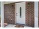 Front door with sidelight, brick surround, and modern lighting create a welcoming entry point at 110 Bayberry Run, Summerville, SC 29485