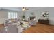 Nicely staged living room features a decorative fireplace, wood flooring and ample natural light at 110 Bayberry Run, Summerville, SC 29485
