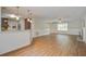 Open-concept living room featuring hardwood floors, a fireplace, and a view of the kitchen at 110 Bayberry Run, Summerville, SC 29485