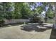 Spacious backyard with a concrete patio, wooden fence, and lush green foliage at 112 Lewisfield Dr, North Charleston, SC 29418