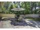Serene backyard featuring a patio with an umbrella, surrounded by lush trees and greenery at 112 Lewisfield Dr, North Charleston, SC 29418