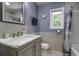 Well-lit bathroom with a marble vanity, neutral tiles, and nautical-themed decorations at 112 Lewisfield Dr, North Charleston, SC 29418