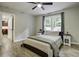Inviting bedroom features a large window, ceiling fan, wood-look floors, and a comfortable bed at 112 Lewisfield Dr, North Charleston, SC 29418