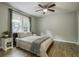 Bright bedroom featuring a ceiling fan, a large window, and a comfortable bed with neutral bedding at 112 Lewisfield Dr, North Charleston, SC 29418