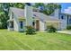 Charming single-Gathering home features a manicured lawn and attached two-car garage at 112 Lewisfield Dr, North Charleston, SC 29418