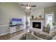 Living room features a cozy fireplace, vaulted ceilings, and abundant natural light at 112 Lewisfield Dr, North Charleston, SC 29418