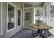 Enclosed porch with a table and chairs, offering a relaxing outdoor living space with views at 112 Lewisfield Dr, North Charleston, SC 29418