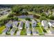 Aerial view of homes and a pond surrounded by lush trees in a community setting at 113 Amaranth Ave, Summerville, SC 29483