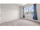 The bedroom offers natural light from a large window with stylish blue curtains and neutral walls at 113 Amaranth Ave, Summerville, SC 29483