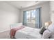 The sun-lit bedroom features neutral walls, soft carpet, and decorative curtains around the bright window at 113 Amaranth Ave, Summerville, SC 29483