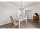 Traditional dining room with decorative chandelier, table for four, and stylish wood flooring at 113 Amaranth Ave, Summerville, SC 29483