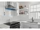 Close-up of a modern kitchen with white cabinets, subway tile backsplash, and stainless steel appliances at 113 Amaranth Ave, Summerville, SC 29483
